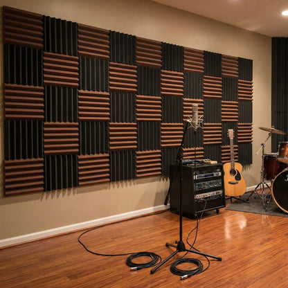 Music studio with acoustic foam panels on the wall, guitar, amplifier, and microphone stand.