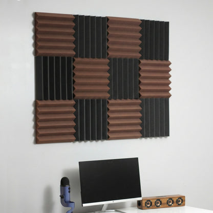 Acoustic foam panels on a wall above a computer setup