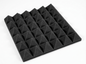 Black pyramid-shaped acoustic foam panels on a white background