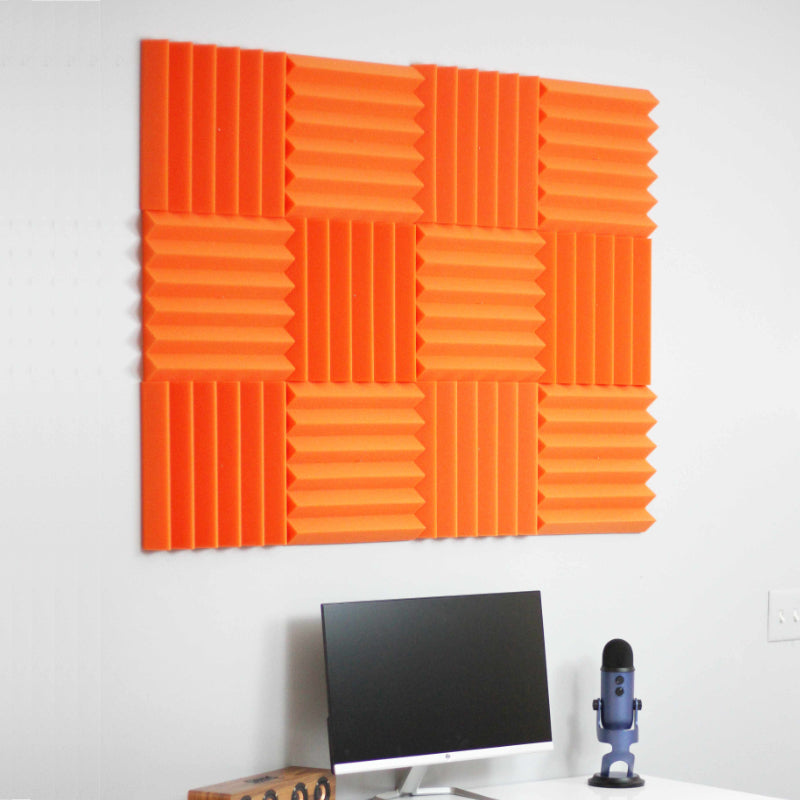 office setup with orange wedge acoustic foam wall tiles