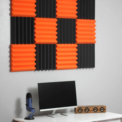 office setup with black and orange wedge acoustic foam wall panels