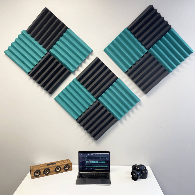 office setup with teal and black wedge acoustic foam wall panels